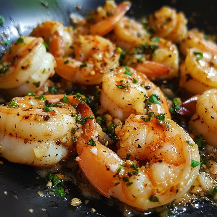 cooked shrimp with herbs and seasoning in a skillet