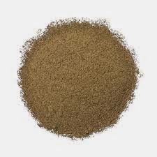 a pile of brown sand sitting on top of a white table