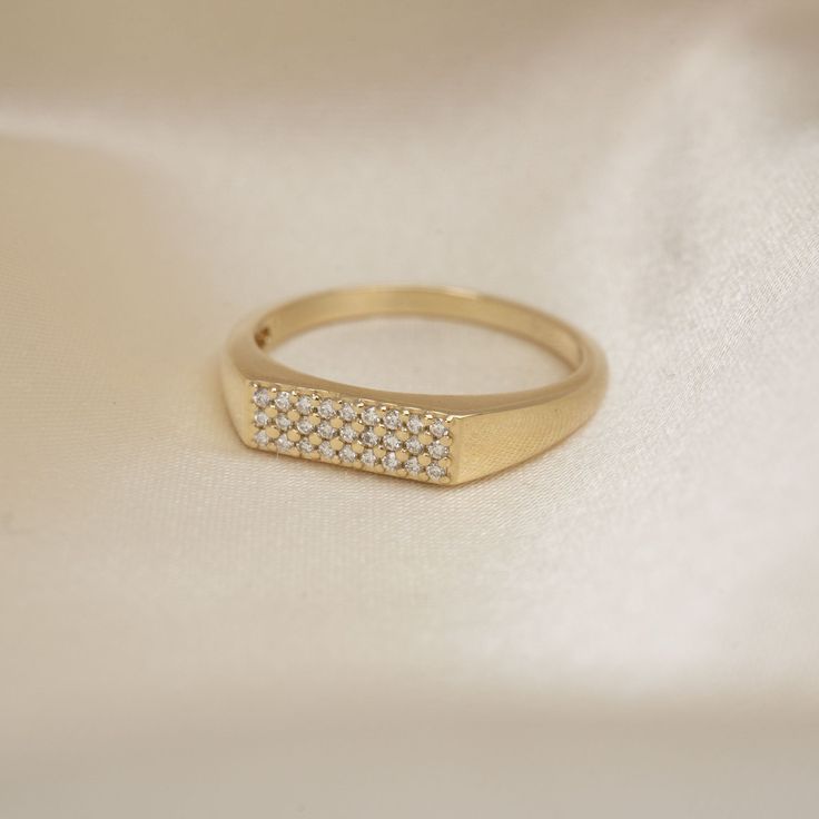 14k Pave Rectangle Signet Ring Part of the Cleo Collection, our 14k Pave Rectangle Signet Ring can be dressed up or down. Featuring 27 genuine, and handset ethically sourced diamonds. .10 CTW Face Dimension: 11.8mm x 4.45mm Built to last a lifetime and more. Due to the handmade nature of this ring, please allow 1 - 3 weeks for processing. Luxury Rings With Diamond Accents And Rectangular Stone, Luxury Rings With Rectangular Diamond Accents, 14k Gold Rings With Diamond Accents, Square Cut, Square Cut Diamond Accent Rings In 14k Gold, Square Cut 14k Gold Rings With Diamond Accents, Luxury Rectangular Diamond Ring With Vs Clarity, 14k Gold Jewelry With Diamond Accents And Square Cut, 14k Gold Rectangular Rings With Diamond Accents, Rectangular 14k Gold Rings With Diamond Accents