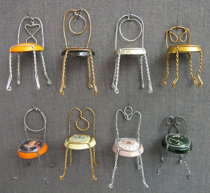 there are many miniature chairs and stools on display