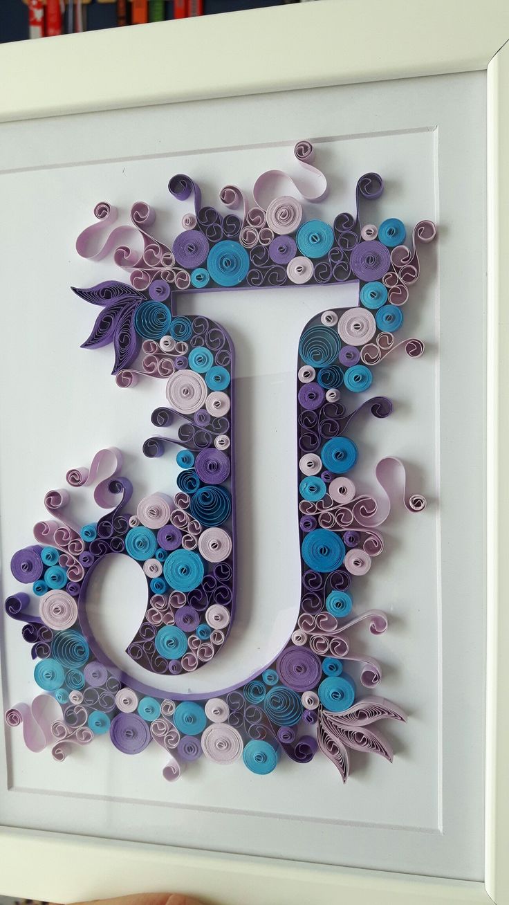 the letter j is made out of paper and buttons