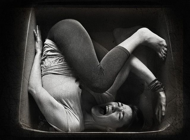 a black and white photo of a woman laying on her back in a tv frame