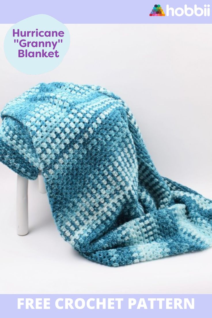 a crocheted blanket sitting on top of a white stool