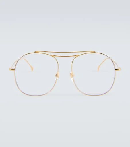 Embrace Gucci’s retro charm in the form of these glasses for an unrivaled addition to your everyday ensembles. They’re made from gold-toned metal into a rounded silhouette with a nose bridge..Frame color: gold.Frame material: metal.comes with cleaning cloth.comes in a hard case.The color of the case may vary.Lens filter category 1.Made in Italy.Lens width: 58mm-2.3'.Bridge size: 18mm-0.7'.Earpiece length: 145mm-5.7' Modern Gold Aviator Sunglasses With Glass Lenses, Classic Gold Aviator Sunglasses With Glass Lenses, Gucci Gold Aviator Sunglasses, Gucci Aviator Sunglasses In Gold, Gucci Gold Rimless Sunglasses, Gold Round Frame Sunglasses With Glass Material, Gold Round Frame Sunglasses With Glass Lenses, Gold Round Frame Sunglasses, Gold Round Frame Glass Sunglasses