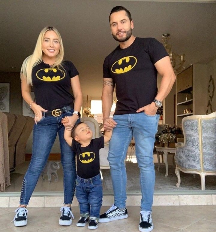 a man, woman and child wearing batman shirts