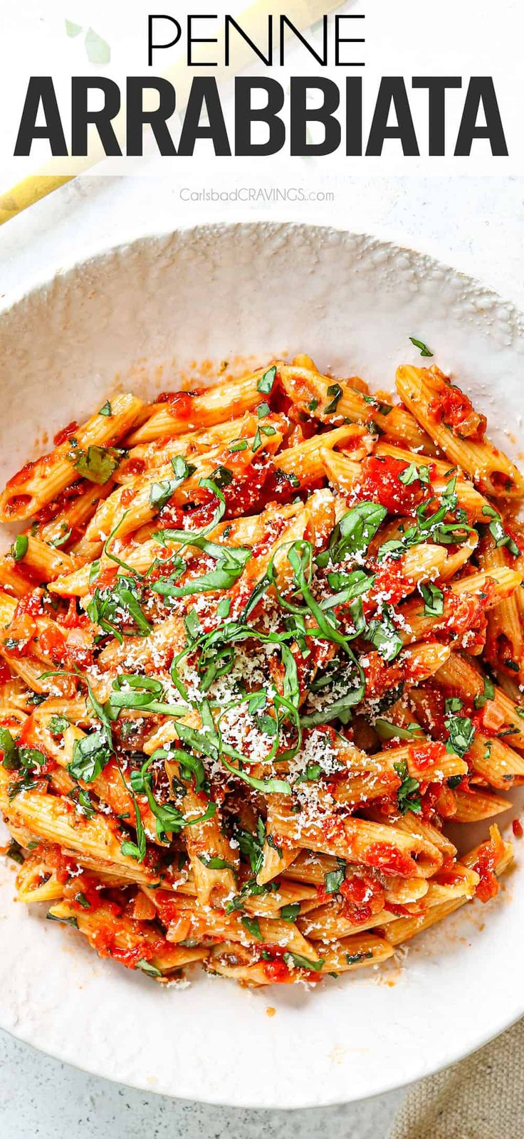 a white bowl filled with pasta covered in marinara sauce and parmesan cheese