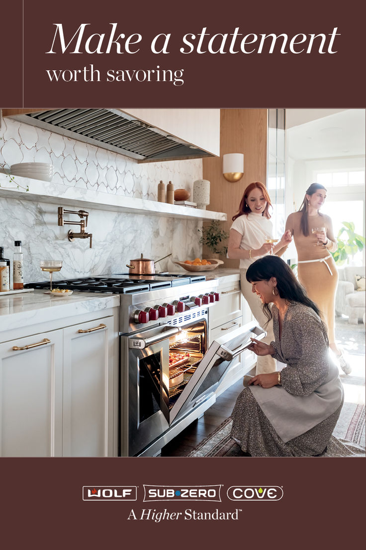 two women looking into an oven while another woman looks at the stove in her kitchen