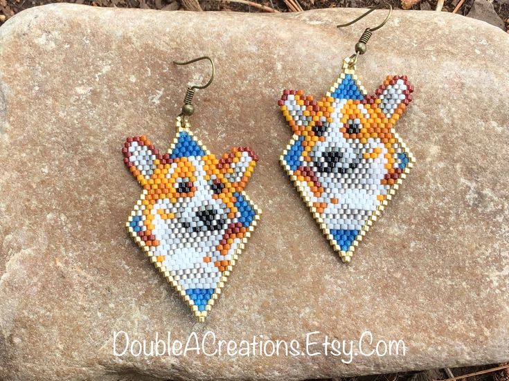 two small beaded earrings with dogs on them