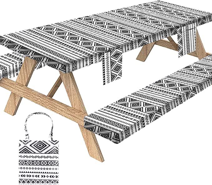 an illustration of a picnic table with black and white patterns on it, next to a handbag