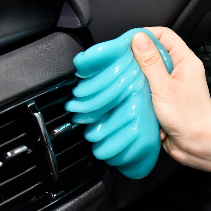 a person is holding the air vent in their hand and cleaning it with a sponge