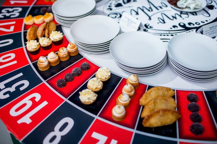 a table topped with lots of different types of plates and cups on top of a roule