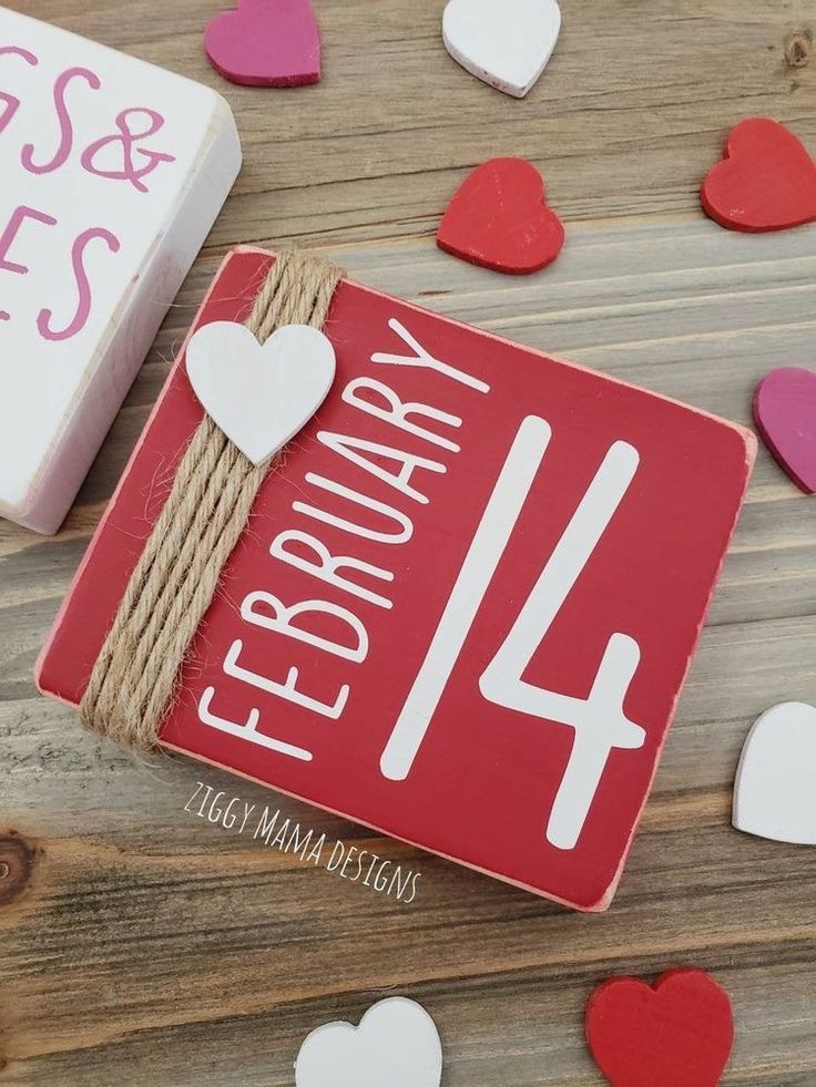 valentine's day card with hearts on wooden table next to box and magnets