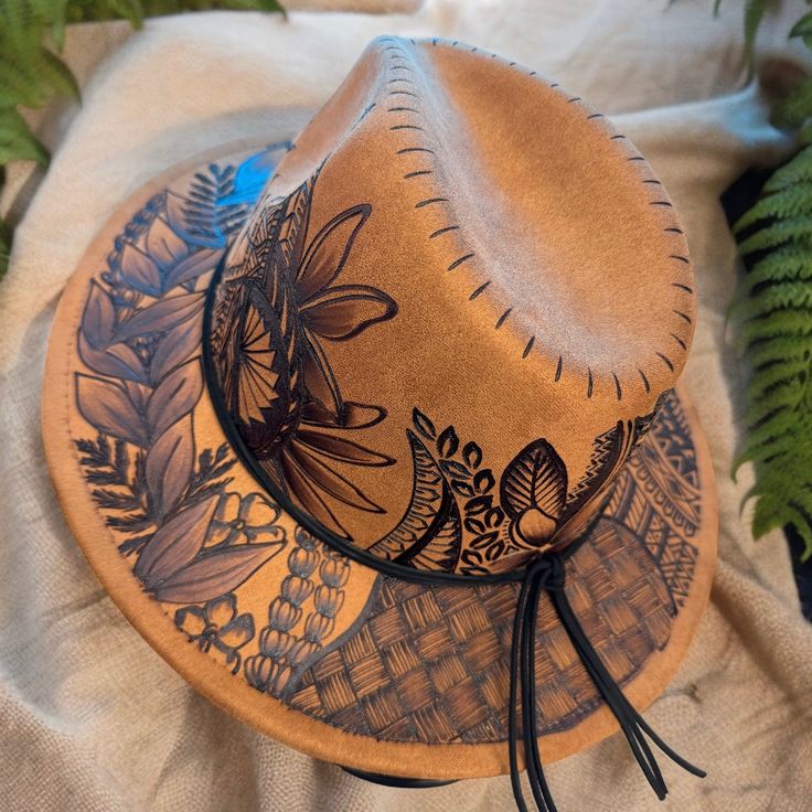 Small Brim Fedora in Khaki. Hat is adjustable from the inner crown for a tighter fit. Burned using Pyrography Techniques. Each Hat is freehanded, making it a hat of its own and a One of a kind. Hats made by Piper come with a Signature travel/dust bag and a handcrafted Macrame Hat Wall Hanger. Hat is sealed for weather for up to 12 months. Brown Mini Hat With Curved Brim For Festival, Brown Curved Brim Mini Hat For Festivals, Wood Burn Hat, Artistic Adjustable Hat For Rodeo, Artistic Short Brim Hat For Rodeo, Artistic Curved Brim Hat For Rodeo, Artistic Flat Brim Hat For Rodeo, Artistic Brown Hats For Festivals, Artistic Brown Hat For Festival