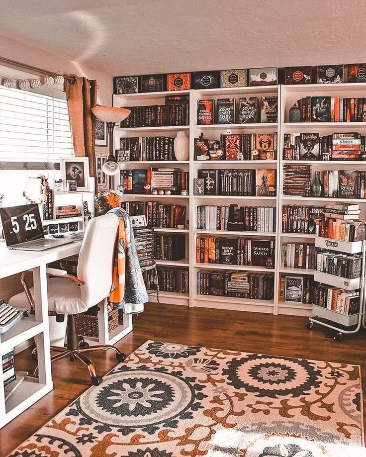 a home office with lots of bookshelves in the corner and a rug on the floor