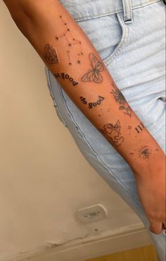 a woman's arm with tattoos on it and words written in the upper half