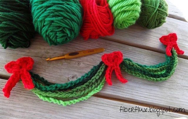 three balls of yarn sitting on top of a wooden table