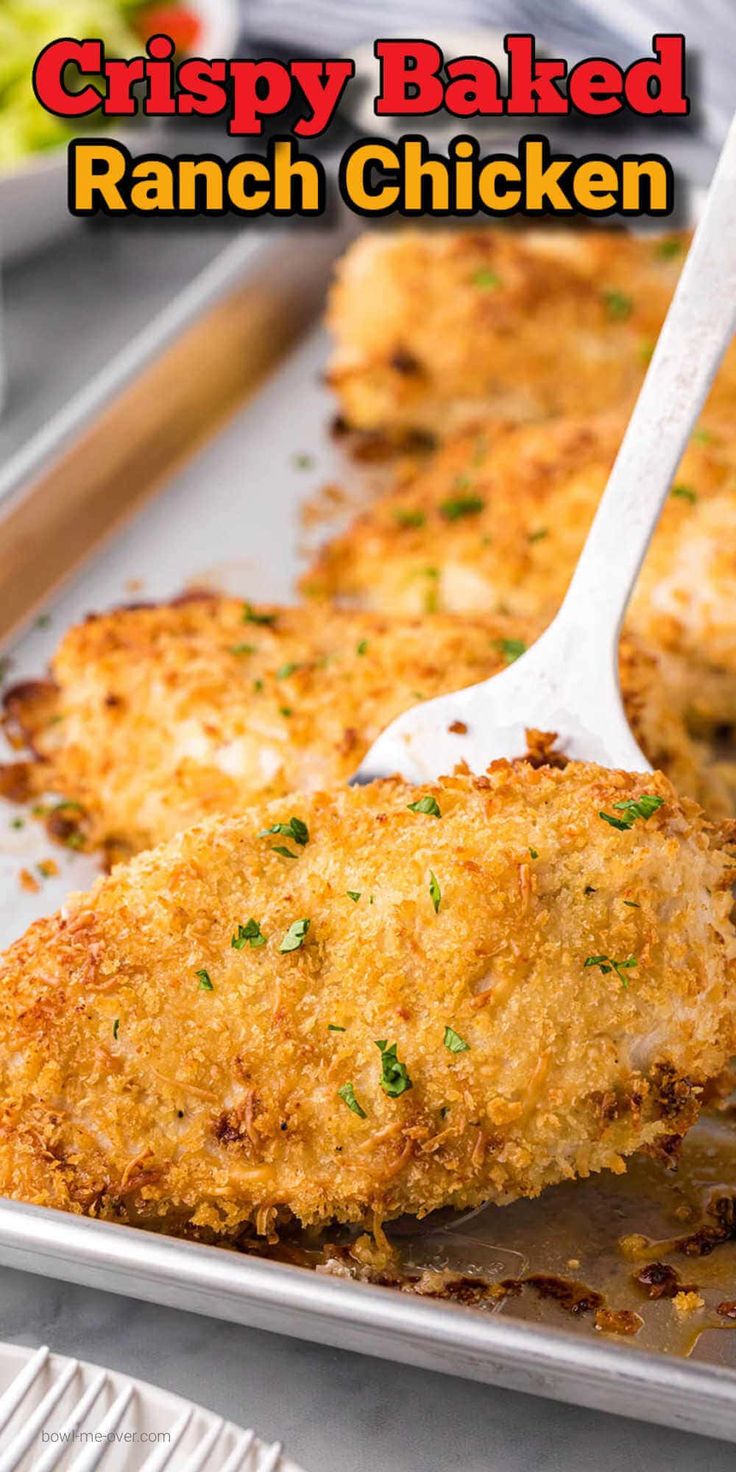 crispy baked ranch chicken on a pan with a spatula