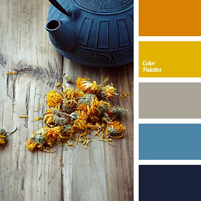 a teapot and some flowers on a wooden table with color swatches in the background