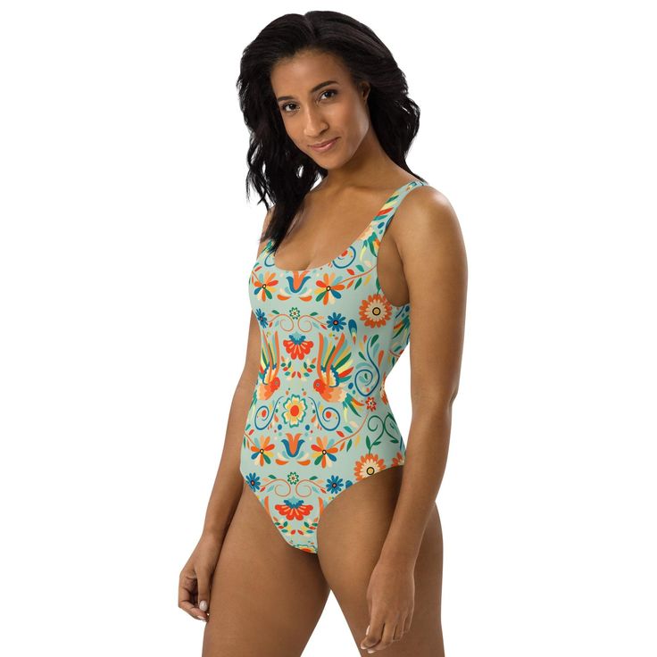 Inspired by the lively motifs of Mexican Otomi art, our One-Piece Swimsuit is a vibrant addition to your beach wardrobe! Against a refreshing light green backdrop, the colorful design adds a touch of flair to your swimwear collection. Dive into style and soak up the sun with every wear! This one-piece swimsuit for all figures will bring out your best features. Enjoy the smooth fabric and the flattering design, and show it off by the sea or pool! Tropical Green Bodysuit For Vacation, Tropical Green Bodysuit For The Beach, Green Printed Beach Bodysuit, Tropical Green One-piece Swimsuit, Green Printed Bodysuit For The Beach, Green Printed One-piece For Vacation, Green Bodysuit For Beach Party, Green Bodysuit For Beach Season Party, Green Bodysuit For Beach Season Vacation