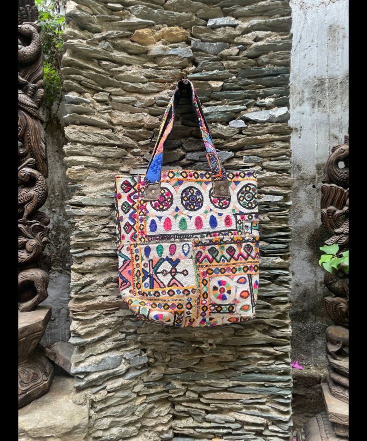 About bag  Indo-gypsy fusion, everyday use hand bag made from Banjara fabrics sourced from Vintage tribal costumes of regions of Rajastan and Gujarat. These are embellished with light catching coins, and intricate bead work tassels. Size - length 15 inches/ width 21 inches Company details:  Company name: Houseoftextile  Contact number: +919784447473  Email id: houseoftextile77@gmail.com  Shipping & custom : Delivery through one of the finest service providers : Skyway, Fedex, UPS  And DHL. Any l Embroidered Multicolor Hobo Tote Bag, Multicolor Festival Tote Beach Bag, Festival Multicolor Embroidered Tote Shoulder Bag, Multicolor Tote Beach Bag For Festivals, Bohemian Multicolor Cotton Canvas Bag, Festival Multicolor Embroidered Hobo Tote Bag, Festival Multicolor Embroidery Hobo Tote Bag, Bohemian Embroidered Multicolor Beach Bag, Multicolor Embroidered Tote Beach Bag