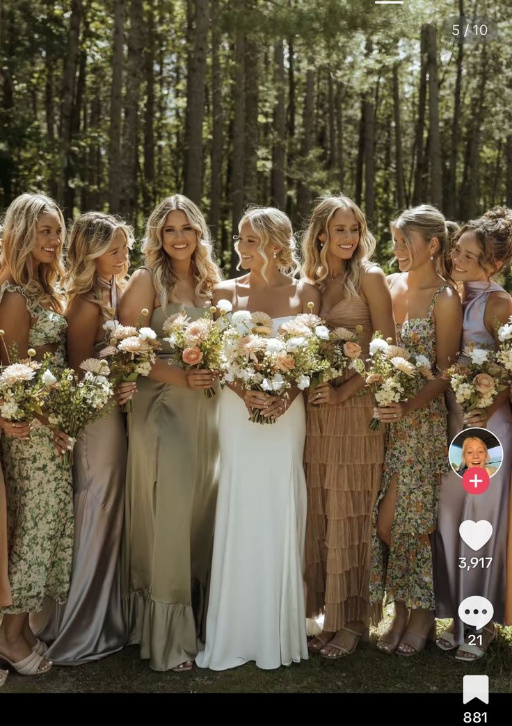 a group of women standing next to each other holding bouquets in front of them