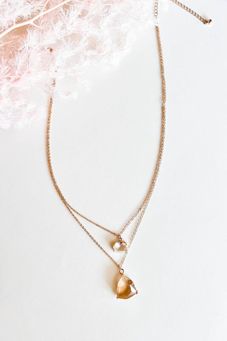 Introducing the Claire Topaz Drop Necklace, an exquisite gemstone necklace that exudes elegance and charm. This captivating piece features a stunning topaz drop pendant suspended from a delicate chain, creating a mesmerizing focal point. With its two-tiered design, this pendant necklace offers a unique layering effect that adds depth and dimension to any ensemble. The Claire Topaz Drop Necklace combines the timeless beauty of gemstones with a modern and versatile style, making it a perfect acces Elegant Drop Birthstone Necklaces, Elegant Drop Birthstone Necklace, Elegant Gold Drop Birthstone Necklace, Elegant Birthstone Drop Necklace, Elegant Drop Shape Birthstone Necklace, Elegant Teardrop Birthstone Charm Necklaces, Elegant Teardrop Birthstone Charm Necklace, Elegant Gold Drop Crystal Necklaces, Formal Teardrop Pendant Necklace With Faceted Detail