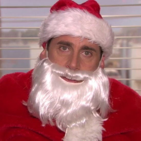 a man in a santa suit with a beard and wearing a santa claus hat is looking at the camera