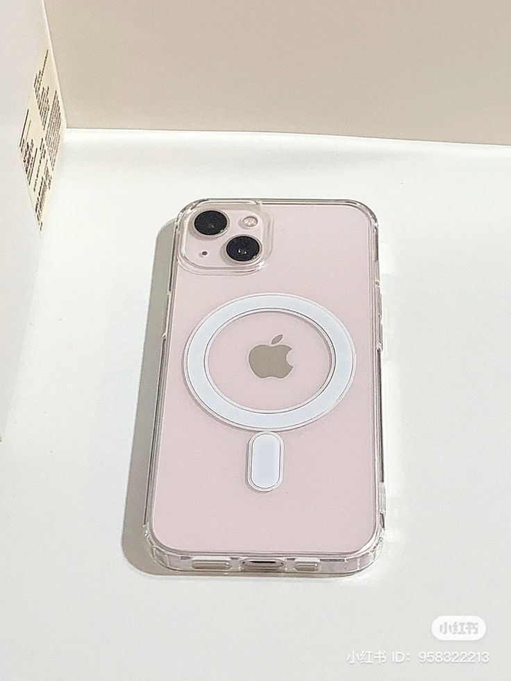 an iphone case sitting on top of a white table next to a box with the phone in it