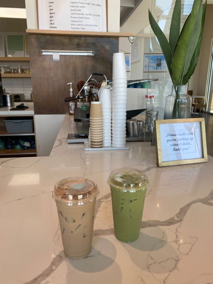 two drinks sitting on top of a white counter