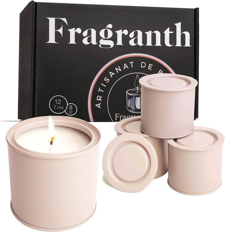 four white candles sitting in front of a black box with the words fragrantth on it