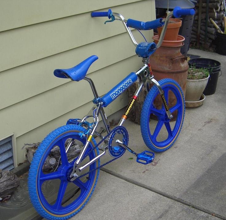 a blue bicycle parked on the side of a house