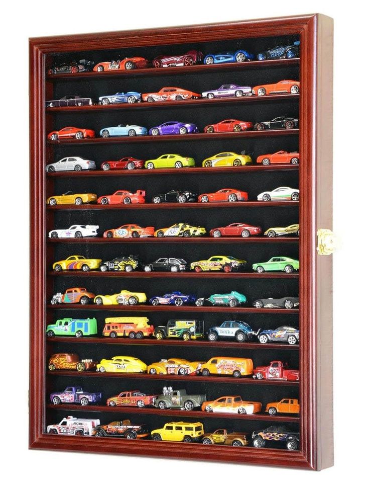 a wooden display case filled with lots of different types of toy cars in it's shelves