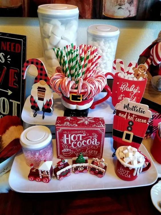 a table topped with candy canes, marshmallows and other holiday treats