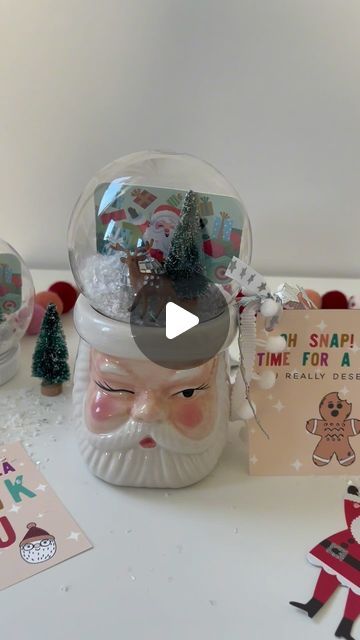 a snow globe sitting on top of a table next to christmas cards and other decorations