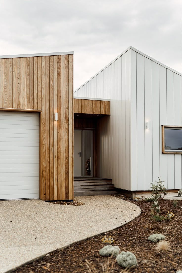 two garages are next to each other on the side of a house that is made out of wood