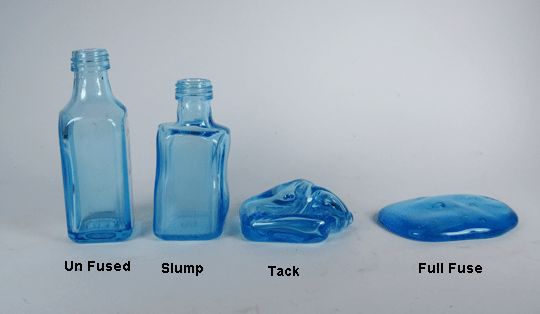 three blue glass bottles sitting next to each other on a white surface with one empty bottle in the middle