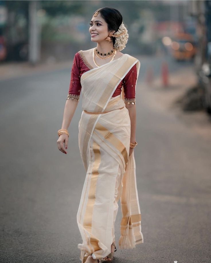 a woman walking down the street in a sari