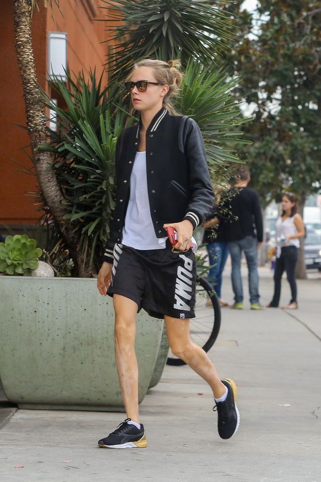 a woman walking down the street in shorts