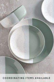 three plates sitting on top of each other in different colors and sizes, with one empty plate next to it