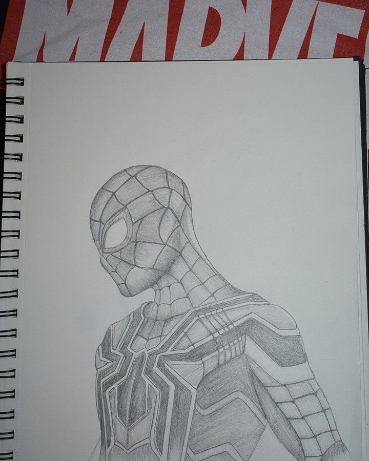 a drawing of a spider - man is shown on a piece of paper