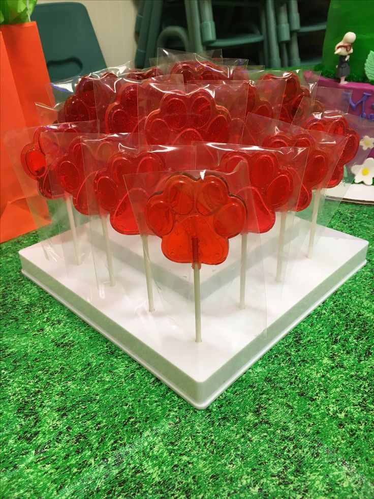 there are many lollipops in the shape of hearts on this display stand