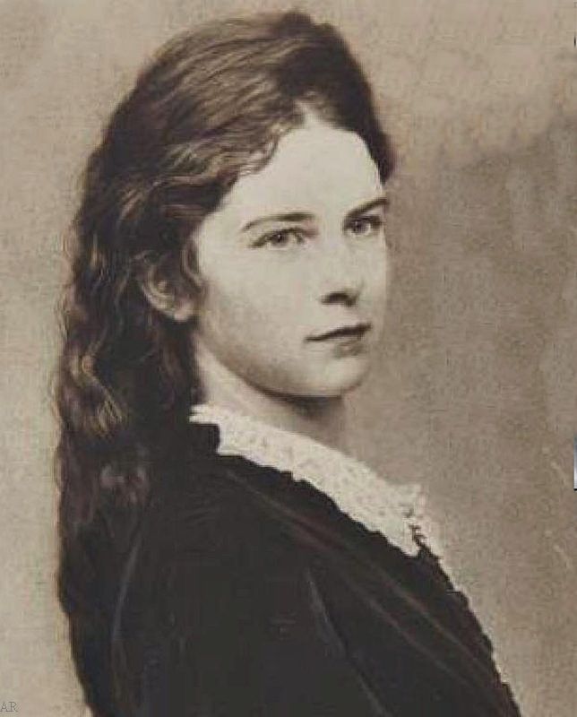 an old photo of a woman with long hair