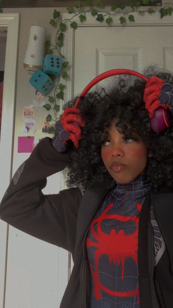 a woman with headphones on standing in front of a door