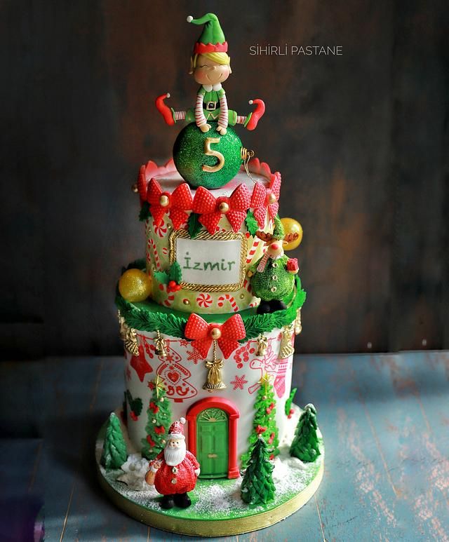 a christmas themed cake with elf on top