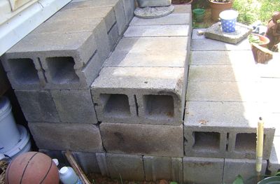 a pile of cinder blocks sitting on top of a patio next to a basketball hoop