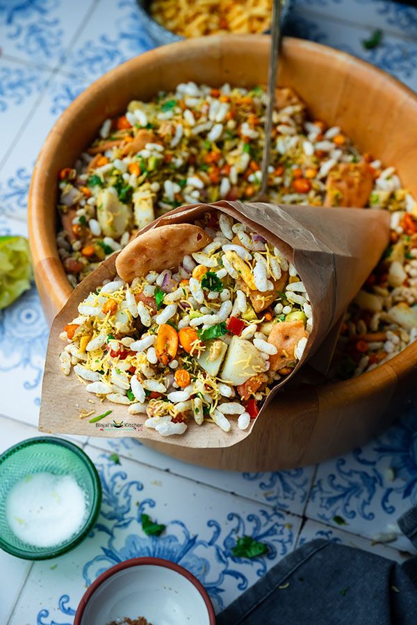 a wooden bowl filled with rice and vegetables