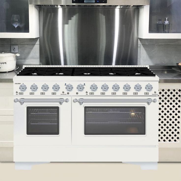 a white stove top oven sitting inside of a kitchen