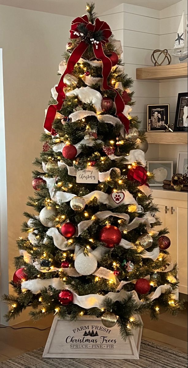 a decorated christmas tree with red and white ornaments