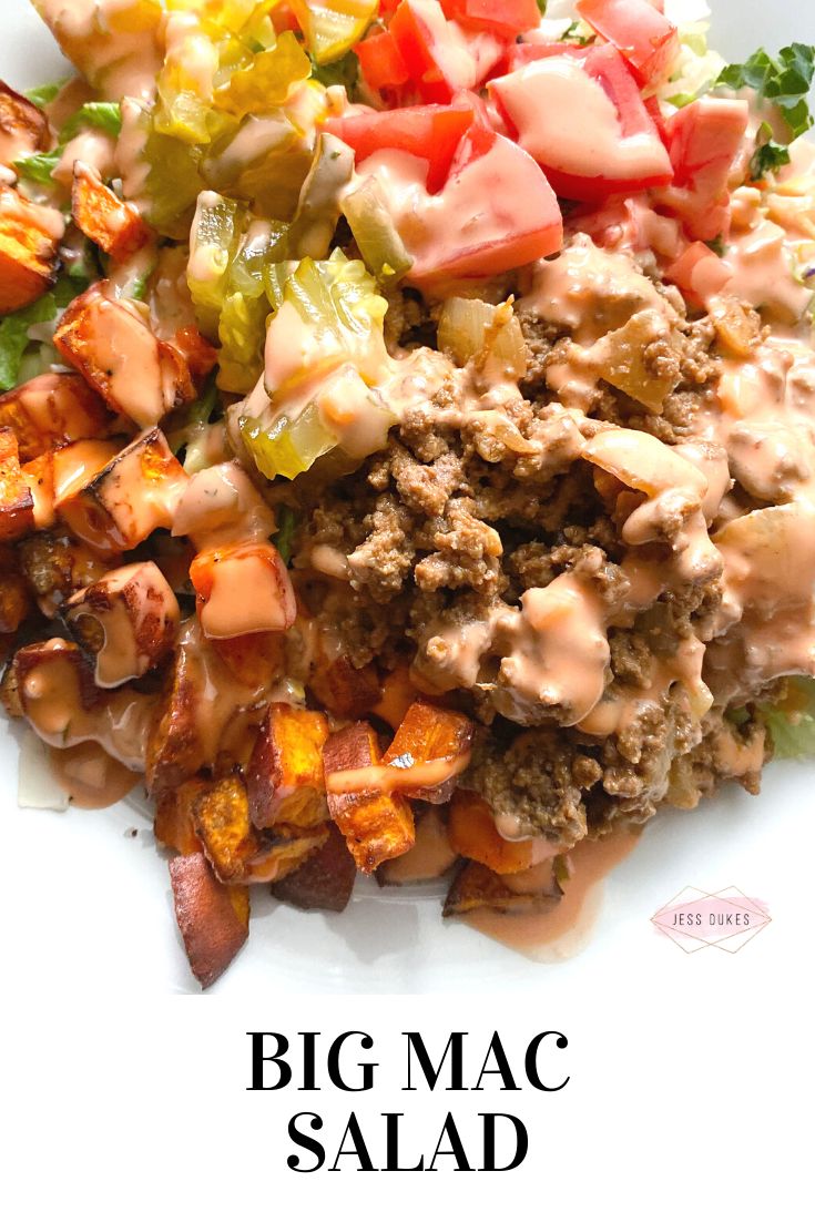 a white plate topped with meat and vegetables on top of lettuce covered in sauce