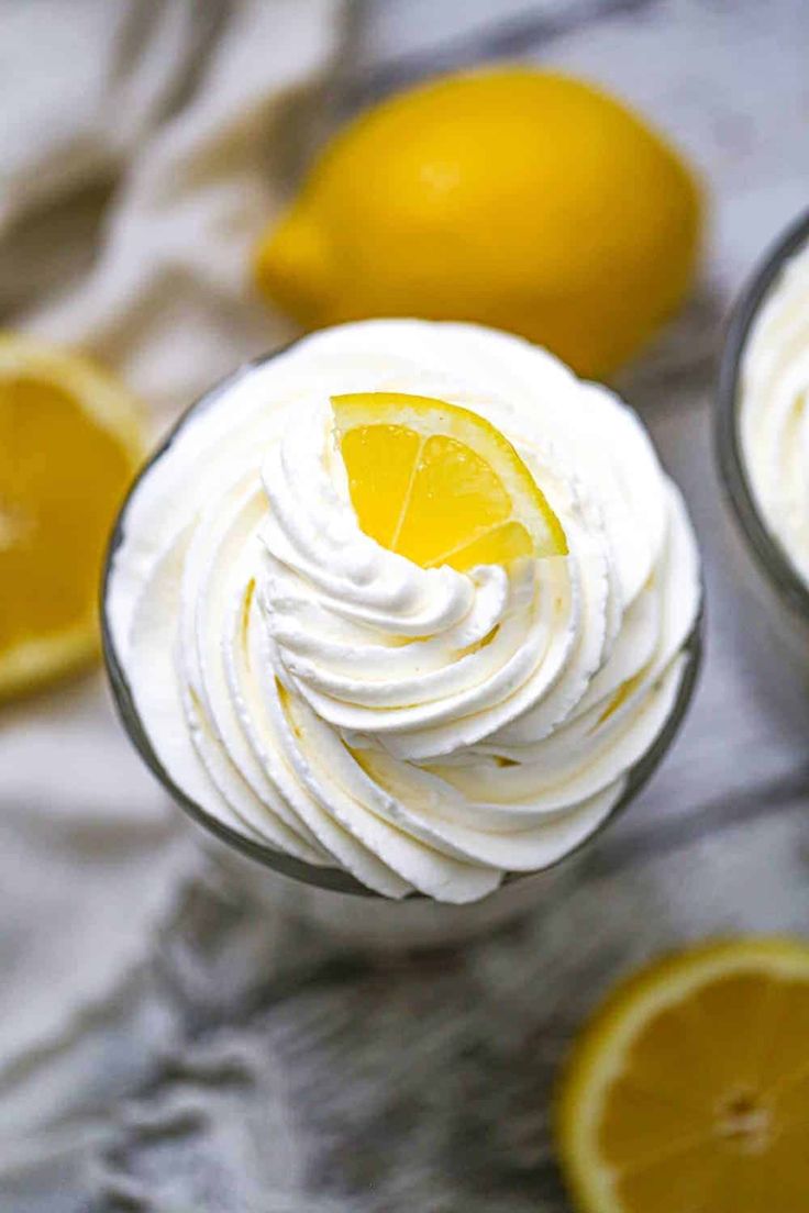 two glasses filled with whipped cream and lemons